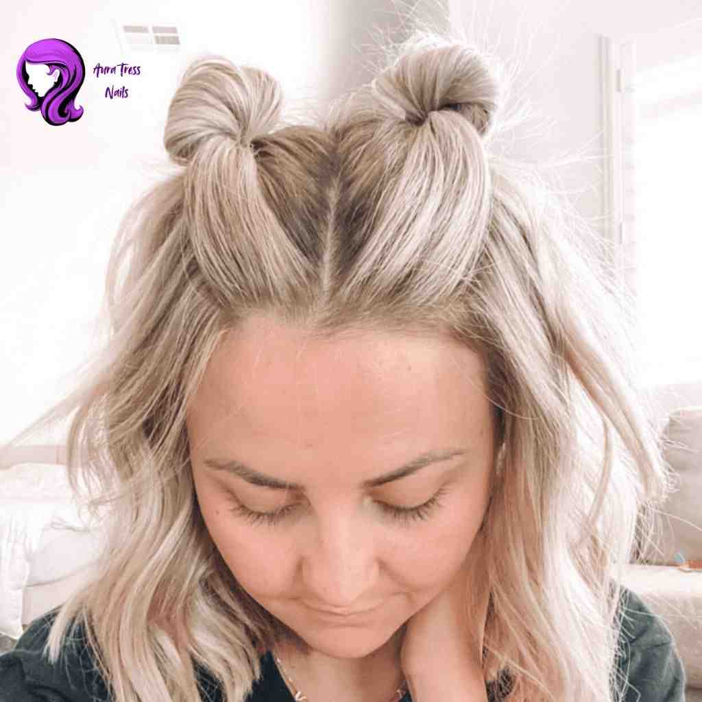 Dua Lipa Half-up space buns hairstyle with loose waves