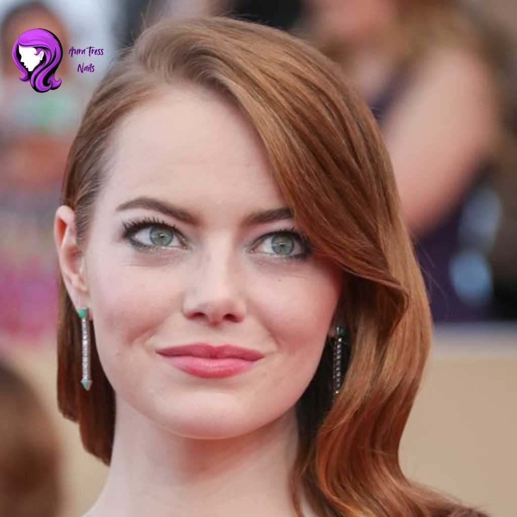 Emma Stone side swept waves hairstyle with soft volume