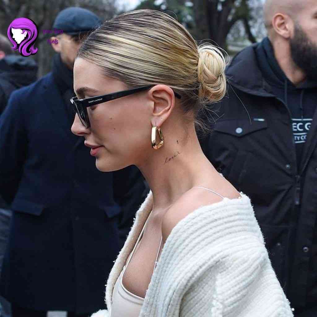 Hailey Biber low sleek bun hairstyle with middle part