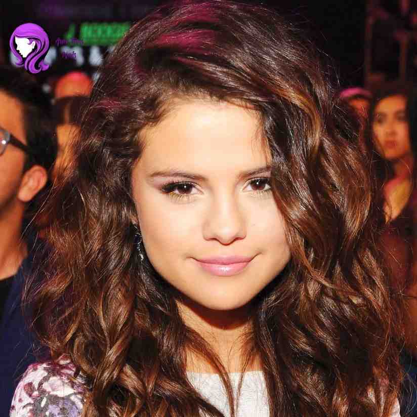 Selena Gomez voluminous curls hairstyle with bouncy texture