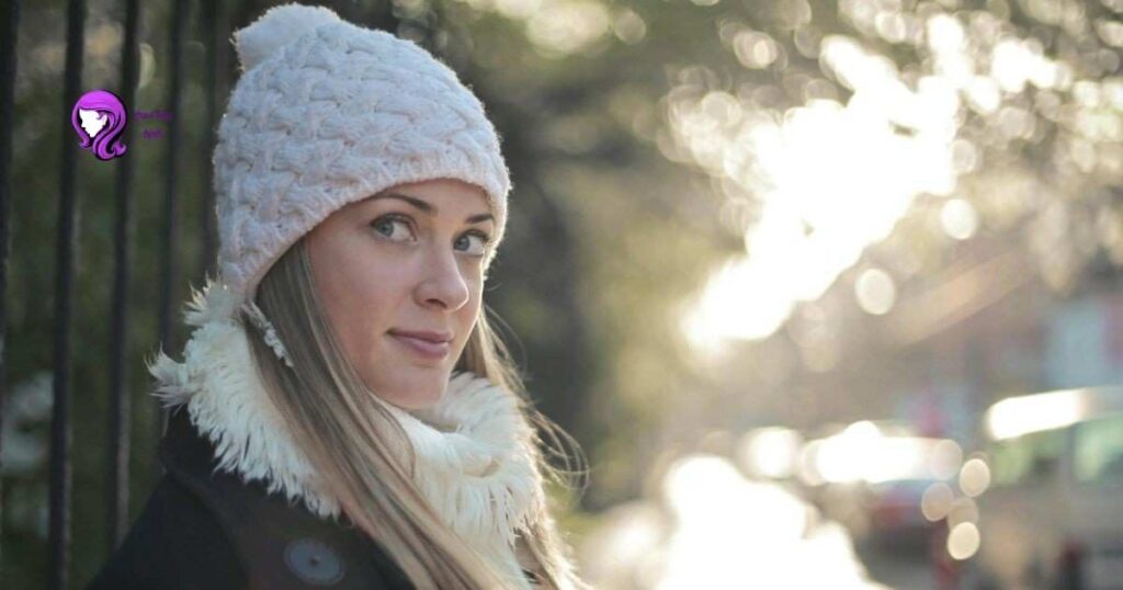 Woman with hair protected under a scarf and winter hat