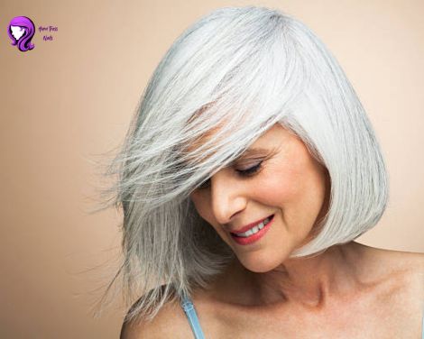 A woman with a sleek chin-length bob haircut, showcasing a timeless and elegant style.