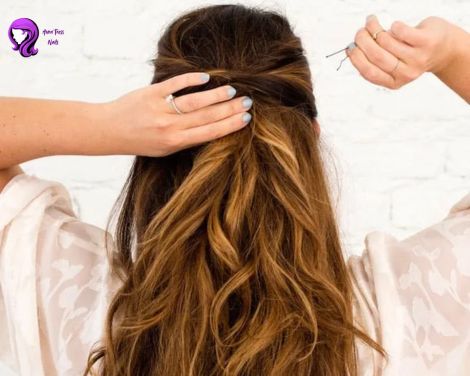 A half-up, half-down hairstyle with loose curls, ideal for a playful yet classy look.