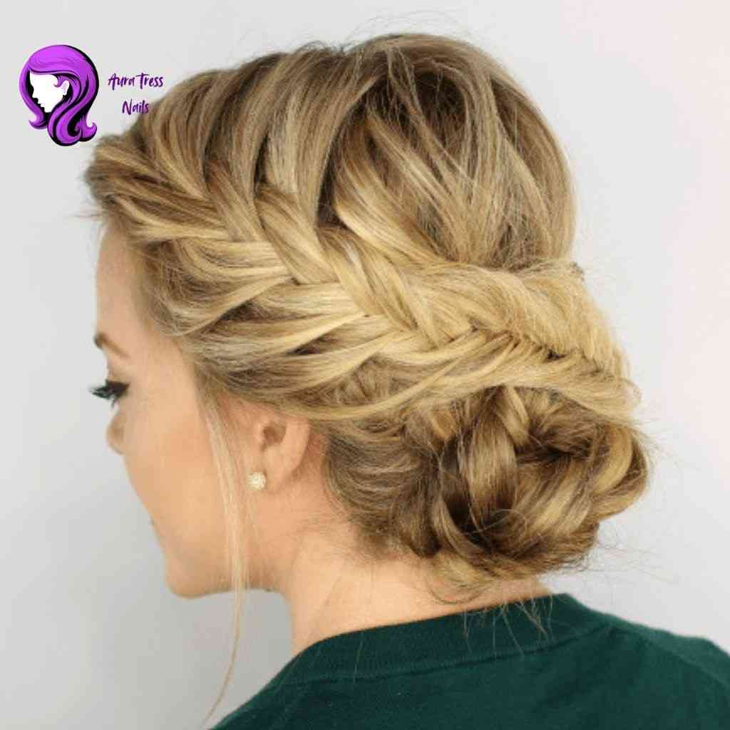 Woman with a loose fishtail braid updo, combining elegance and relaxed style