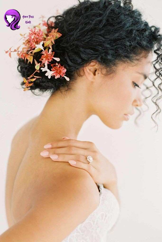Girl with a messy low bun hairstyle with loose strands framing her face