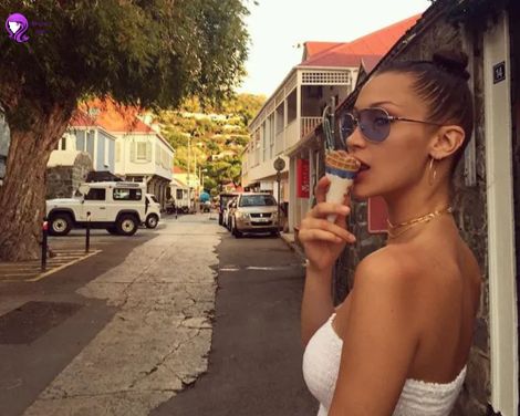 A sleek wet hair look inspired by Bella Hadid, featuring a glossy, brushed-back style that exudes modern elegance.