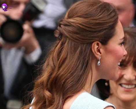 A classic half-up, half-down hairstyle inspired by Kate Middleton, with soft waves and the top section elegantly pinned back.
