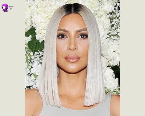 A chic and polished sleek bob hairstyle inspired by Kim Kardashian, featuring straight, shiny hair with a center part.