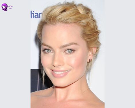 A romantic braided crown hairstyle inspired by Margot Robbie, featuring intricately woven braids wrapped around the head for an elegant look.