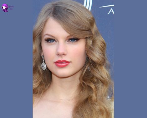 Elegant side-swept curls inspired by Taylor Swift, featuring soft, romantic waves cascading over one shoulder.