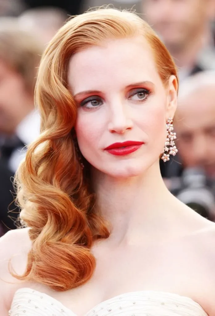 Jessica Chastain with vintage Hollywood waves, elegant red carpet hairstyle.