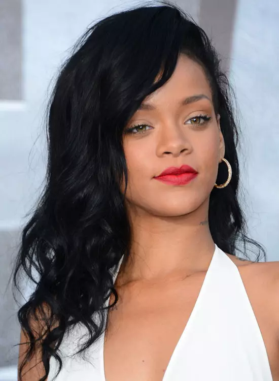 Natural waves with a deep side part, inspired by Rihanna's signature effortless style.